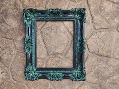 a green frame sitting on top of a stone wall