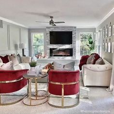 a living room filled with furniture and a flat screen tv mounted on the wall over a fireplace