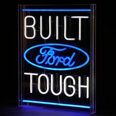 a neon sign that says built ford tough on it's side in front of a black background