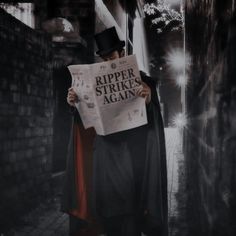 a man wearing a top hat and cape holding a newspaper while standing in an alleyway