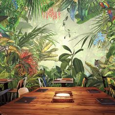 an image of a jungle scene with many plants and animals on the wall behind the table