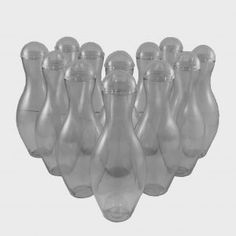 six clear glass vases are lined up in a row on a white background,