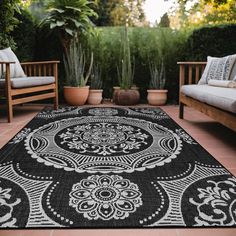 a black and white rug sitting on top of a patio