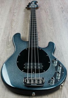 an electric guitar laying on top of a wooden floor