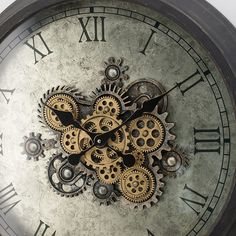 an old clock with gears attached to it's face is shown in this image