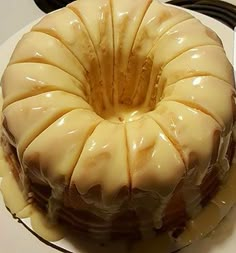 a bundt cake sitting on top of a white plate next to a black wire