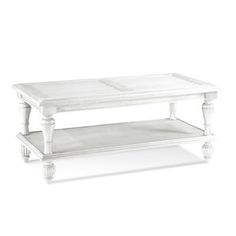 a white coffee table sitting on top of a white floor