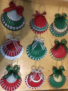 christmas ornaments are hanging from the ceiling in different colors and patterns, including red, green, and white