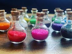 small bottles filled with different colored sand on top of a table