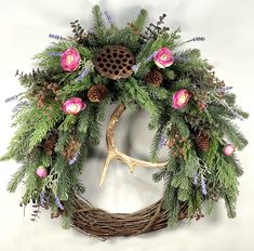 a wreath with flowers and antlers on it