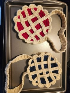 three crocheted items are sitting in a pan on top of each other and one is red white and blue