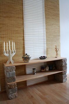 a wooden shelf with candles on it in a room