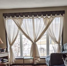 a living room with a dog sitting on the couch