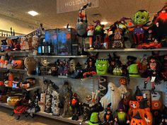 a shelf filled with lots of halloween decorations and figurines on top of shelves