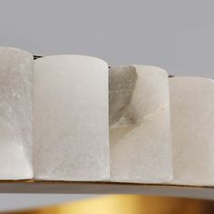 four pieces of white marble sitting on top of a table