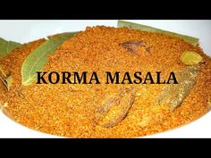 the words korma masala are written in black on a white plate with leaves