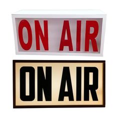 two red and white signs that say on air and on air with the letters below them