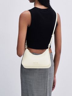 This product is made with at least 20% sustainable materials by weight. CHARLES & KEITH uses recycled, degradable, organic, and water-based materials in our eco-conscious collection. For a minimalist yet striking bag, look no further than this versatile cream trapeze bag. Featuring a sleek silhouette with soft rounded corners, this piece offers ample space that can easily hold your everything essentials and more. Complete with a shiny gold-toned chain featuring a lock and key detail, it will certainly set you apart from the crowd. Trapeze Bag, Locks & Key, Size Chart For Kids, Lock And Key, Charles Keith, Luggage Accessories, Printables Kids, Lunar New, Eco Conscious