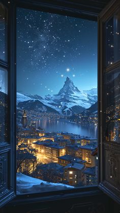 an open window looking out at the snow covered mountains and city lights in the distance