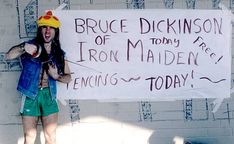 a man with long hair wearing a hat and holding a sign that says bruce dickinson of today is iron maiden tennis today