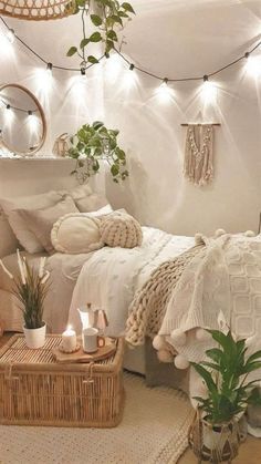 a white bedroom with plants and lights on the wall