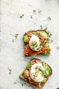 two open faced sandwiches with avocado and poached eggs