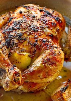 a roasted chicken with olives in a pan