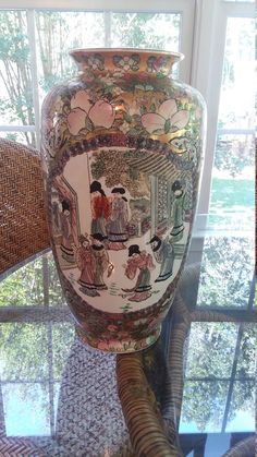 a large vase sitting on top of a glass table