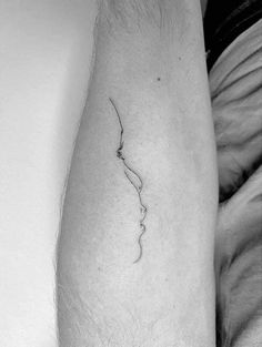 a black and white photo of a person's leg with a tattoo on it