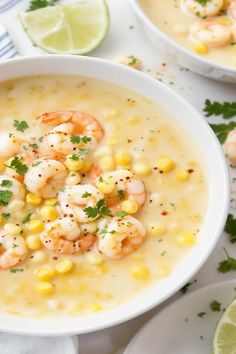 two white bowls filled with shrimp and corn soup