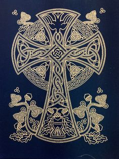 an intricately designed cross with birds and flowers in gold on a blue background,