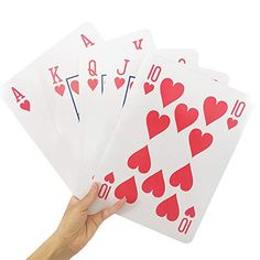 a hand holding four playing cards with red hearts on each card and the number ten