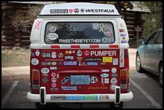 a red and white van with stickers on it