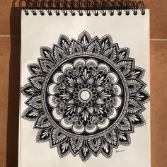 a spiral notebook with an intricate design on it