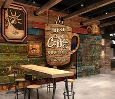 the interior of a coffee shop with wooden tables and stools