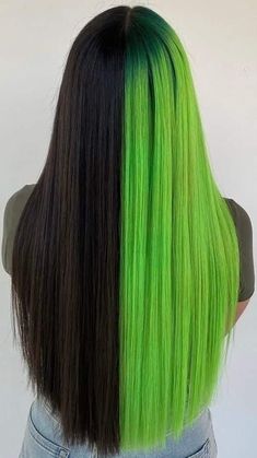 the back of a woman's head with bright green hair and black to dark roots