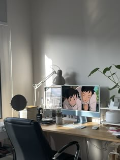 an office desk with two monitors and a plant in the corner on top of it