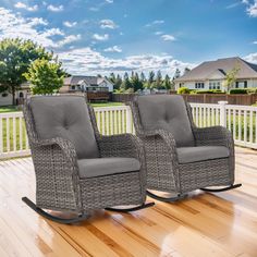 two rocking chairs sitting on top of a wooden deck