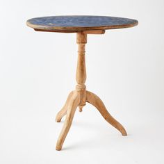 a small wooden table with a blue top