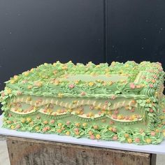 a large green cake sitting on top of a table