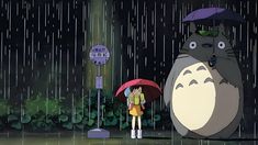 a person holding an umbrella standing in the rain with a totoro behind them