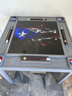 an american flag painted on the side of a table with pencils and pens in it