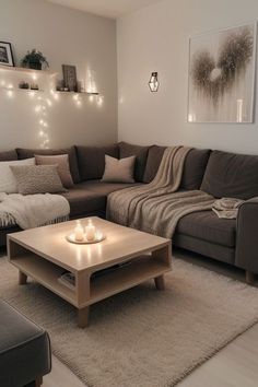 a living room filled with furniture and candles on the coffee table in front of it