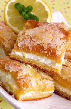 lemon cream cheese bars on a white plate