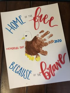 a sign that reads home of the free because of the brave with an eagle painted on it