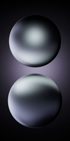 two shiny rocks on a black background