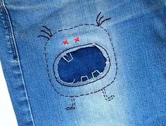 a pair of blue jeans with an embroidered design on them