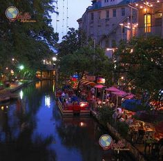 a river with boats and people on it at night