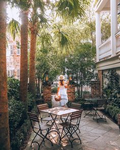 the instagram page shows an image of a woman sitting at a table in front of palm trees