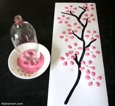 a paper plate with pink icing on it next to a painting and a vase